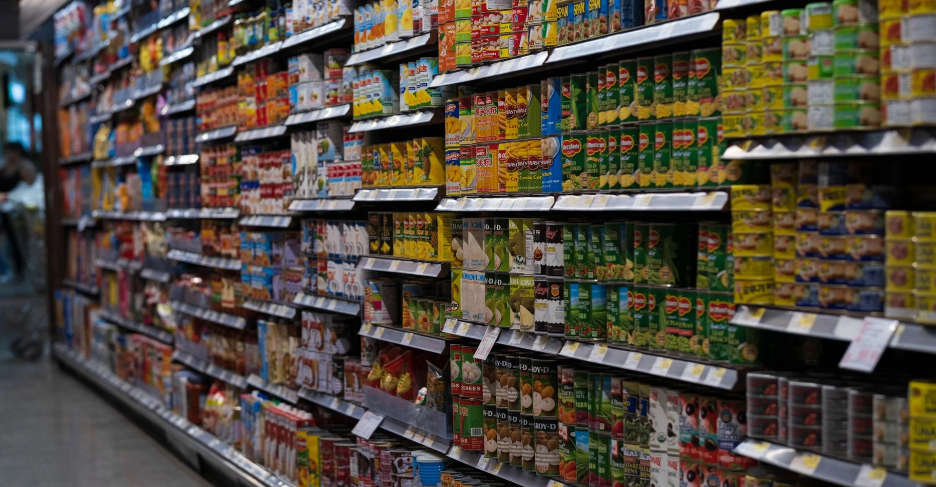 Grocery shelves lined with products and sale tags