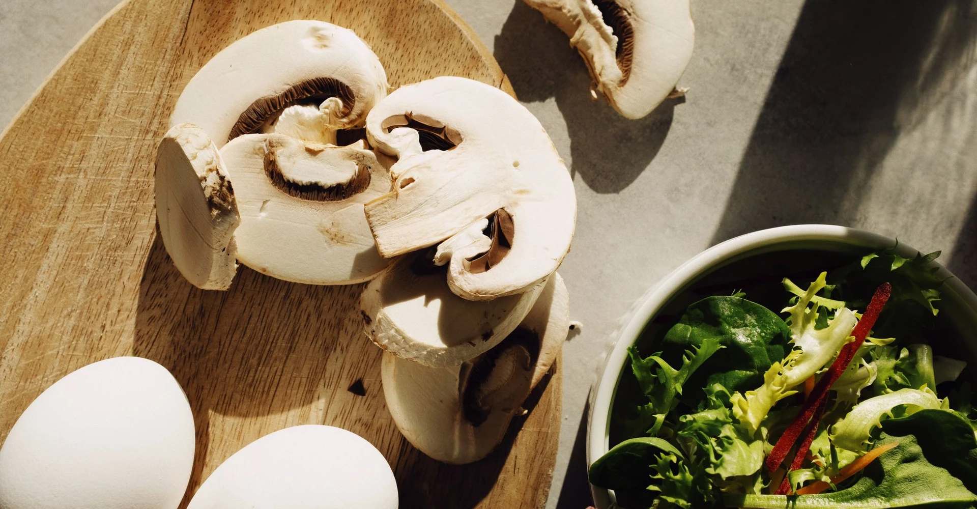 Mushrooms, eggs and salad greens ready for cooking